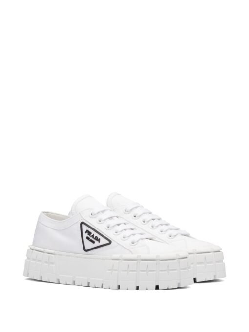 Sneakers with triangular logo sign